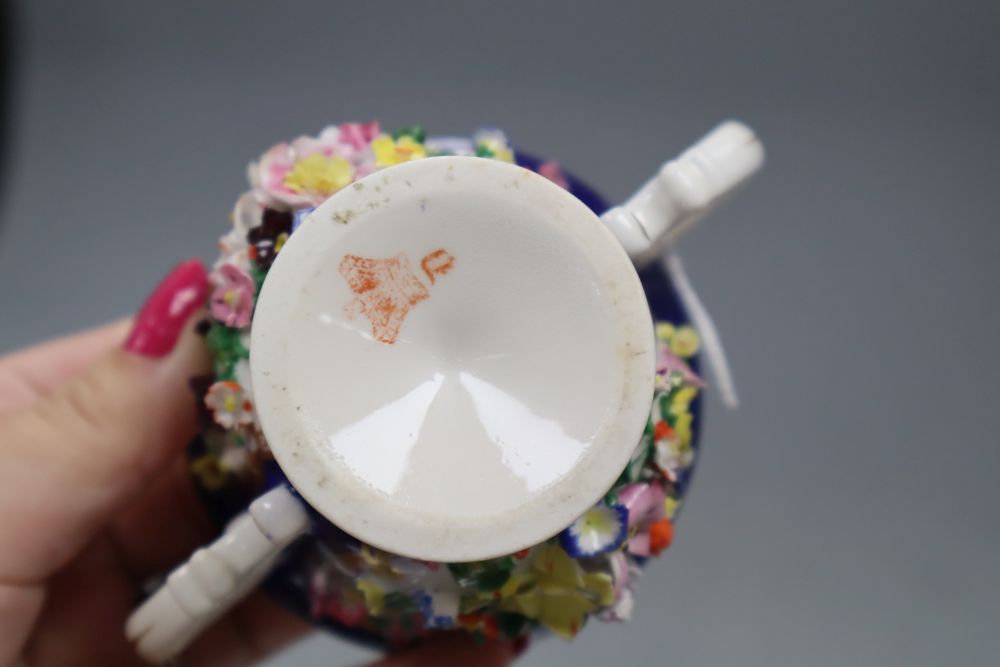 A Bloor Derby floral encrusted two handled cup and saucer, red printed factory mark